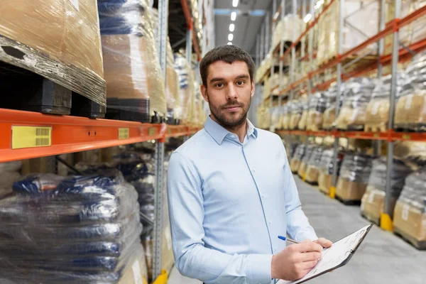 Businessman with clipboard at warehouse — Stock Photo, Image