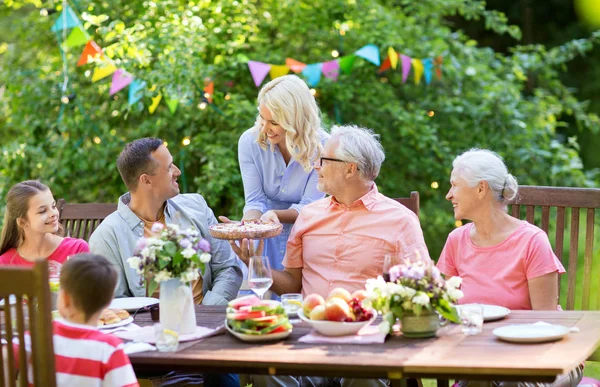 Happy family have food or summer garden party – stockfoto