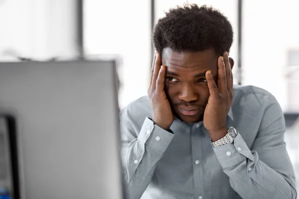 Stressed businessman with computer at office — Stock Photo, Image