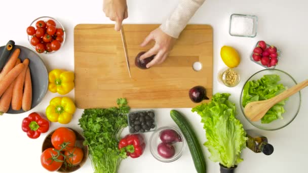 Young woman chopping red onion at home — Stock Video