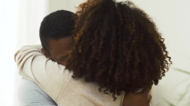 Happy african american couple hugging at home — Stock Video