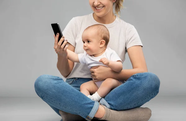 Mère et bébé regardant smartphone — Photo