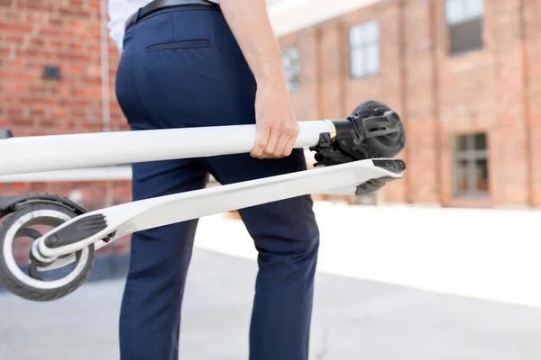 Businessman with folding scooter in city — Stock Photo, Image