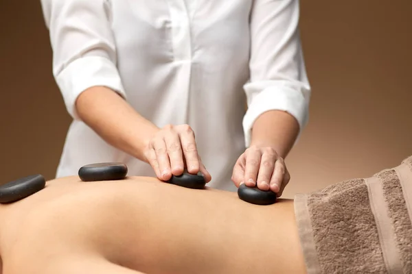 Close up of woman having hot stone massage at spa — Stock Photo, Image