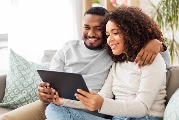 Casal afro-americano com tablet pc em casa — Fotografia de Stock