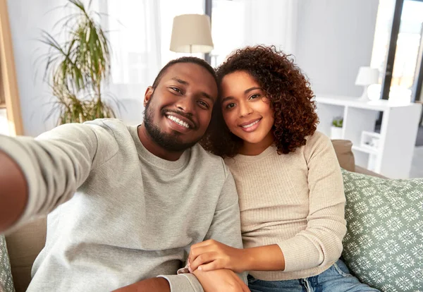 African american couple taking selfie at home — Stok Foto