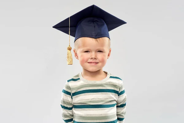 Smiling little boy in mortar board — Stock Photo, Image