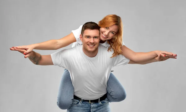 Happy couple in white t-shirts having fun — Stock Photo, Image