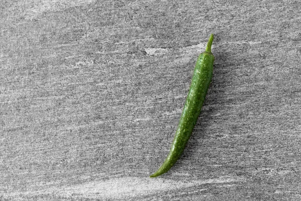 Green chili pepper on slate stone background — Stock Photo, Image