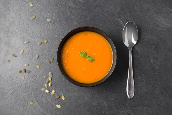Vegetable pumpkin cream soup in bowl with spoon — Stock Image Vegetable pumpkin cream soup in bowl with spoon Stock Picture