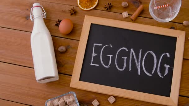 Eggnog word on chalkboard, ingredients and spices — Stock Video