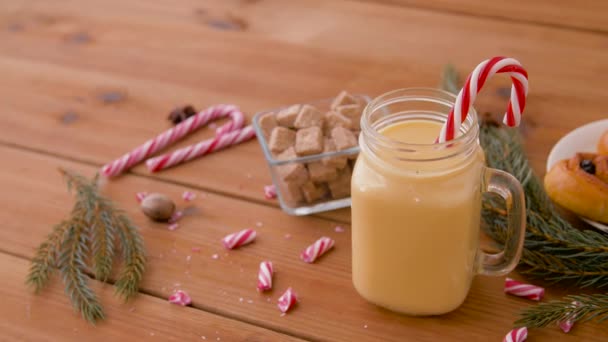 Glass mug of eggnog, ingredients and sweets — Stock Video