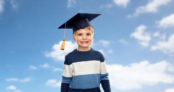 Little boy in bachelor hat or mortarboard over sky — Stock Photo, Image