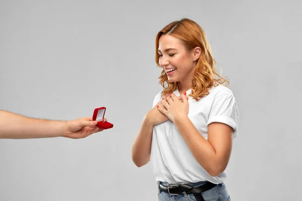 man giving woman engagement ring on valentines day