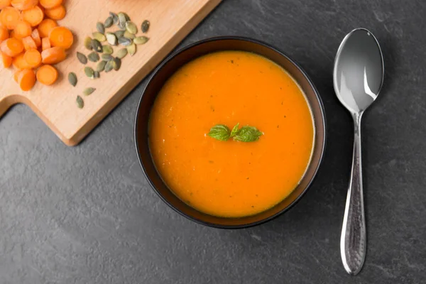 Vegetable pumpkin cream soup in bowl with spoon — Stock Image Vegetable pumpkin cream soup in bowl with spoon Stock Picture
