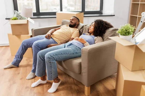 Couple with boxes tired after moving to new home — ストック写真