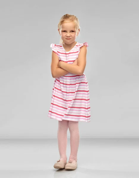 Displeased little girl with crossed arms pouting — Stock Photo, Image