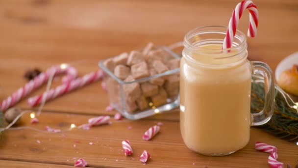 Glass mug of eggnog, ingredients and sweets — Stock Video