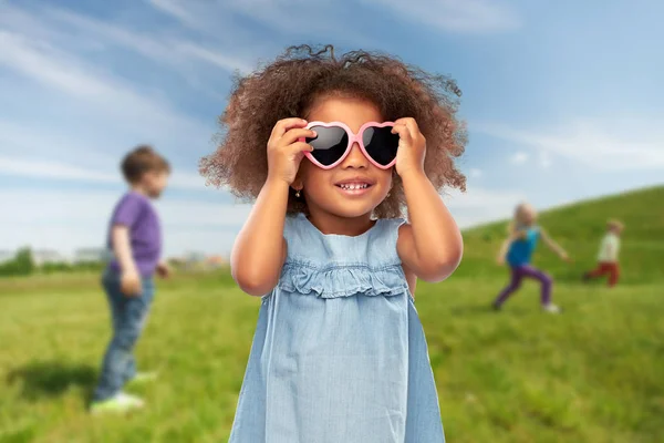 Liten afrikansk flicka i hjärtformade solglasögon — Stockfoto