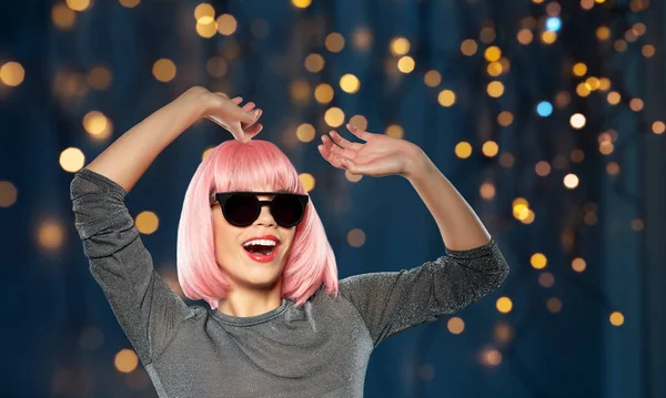 Happy woman in pink wig and sunglasses dancing — Stock Photo, Image