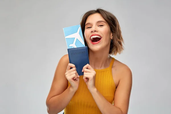 Ευτυχισμένη νεαρή γυναίκα με αεροπορικό εισιτήριο και διαβατήριο — Φωτογραφία Αρχείου