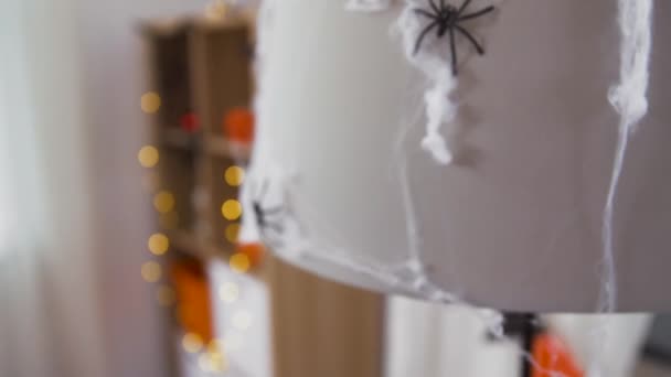 Halloween decoration of black toy spider on cobweb — Stock Video