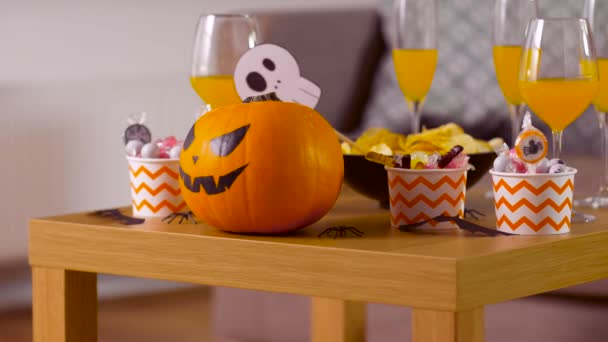 Halloween decorations and treats on table at home — Stock Video