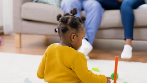 African baby girl playing with toy blocks at home — Stock Video