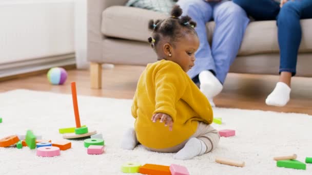 African baby girl playing with toy blocks at home — Stock Video