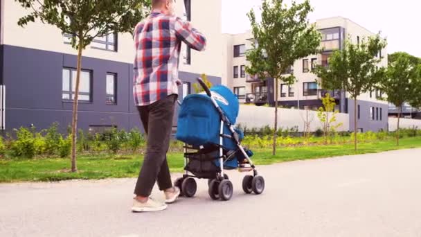 Far med baby i barnvagn och fika i City — Stockvideo