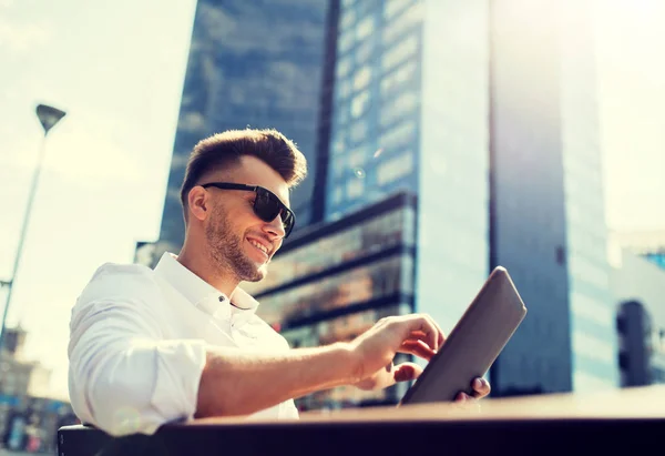 Mann mit Tablet-PC sitzt auf Stadtbank — Stockfoto