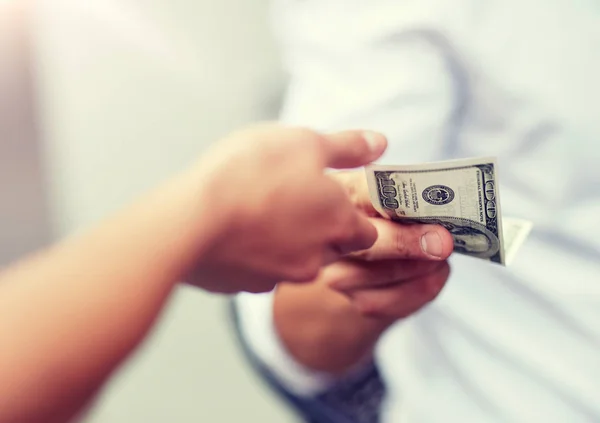 Close up of hands giving and receiving dollar money — Stock Photo, Image