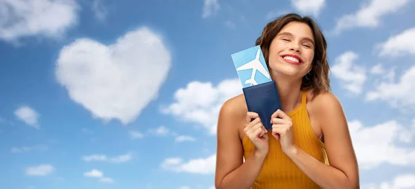 Happy young woman with air ticket and passport — Stock Photo, Image