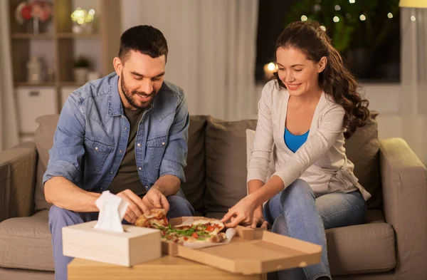 Happy couple eating takeaway pizza at home — Stock Photo, Image