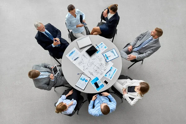 Business team with gdgets and papers at office — Stock Photo, Image