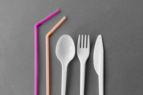 disposable plastic fork, knife, spoon and straws