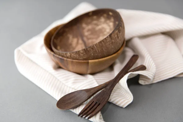 Close up of coconut bowl, wooden spoon and fork — Stock Photo, Image