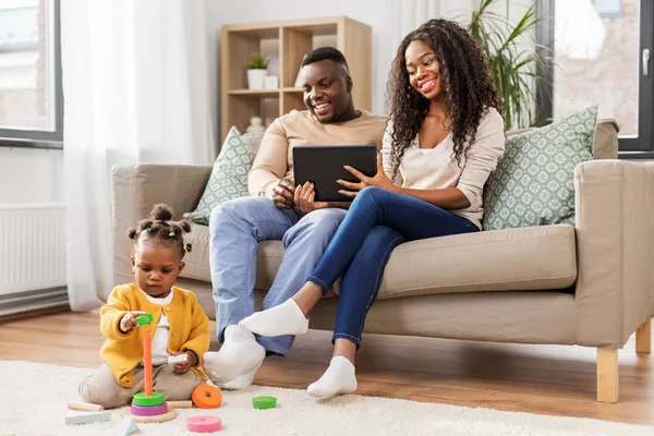 Family with tablet pc and toy blocks at home — ストック写真