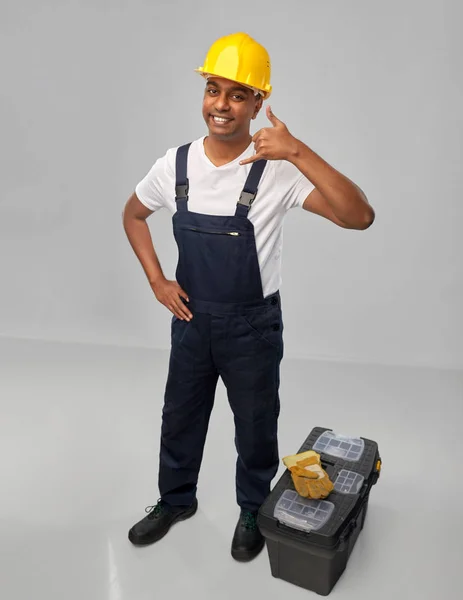 Happy worker or builder making phone call gesture — Stock Photo, Image