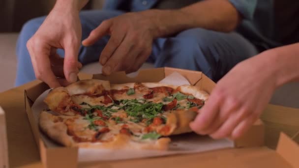 Lyckliga par äter hämtmat pizza hemma — Stockvideo