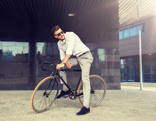 Hombre con bicicleta y auriculares en la calle de la ciudad — Foto de Stock