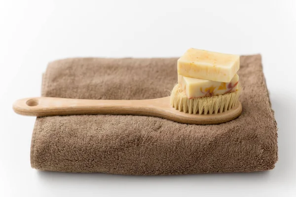 Crafted soap bars, natural brush and bath towel — Stock Photo, Image