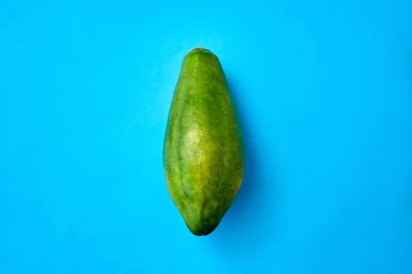 Primer plano de papaya madura sobre fondo azul — Foto de Stock
