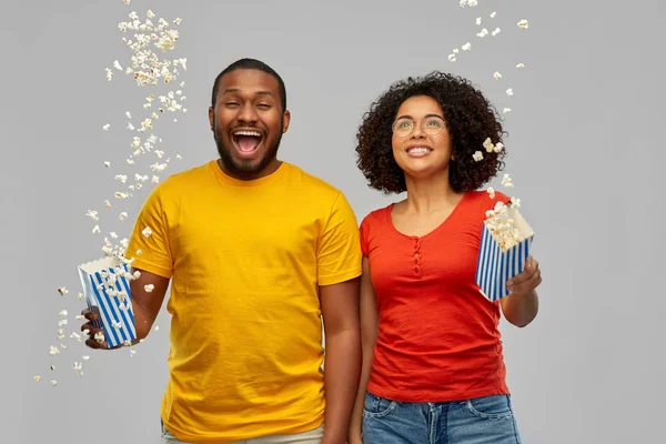 Happy african american couple with popcorn — Stock Photo, Image