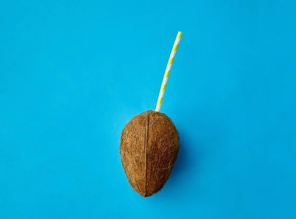 Coconut drink with paper straw on blue background — 스톡 사진