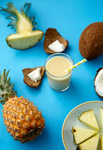 Pineapple, coconut and drink with paper straw — 스톡 사진