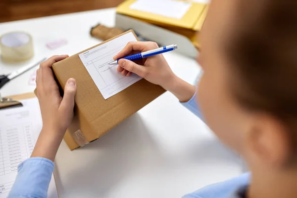 Gros plan de la femme remplissant le formulaire postal au bureau — Photo