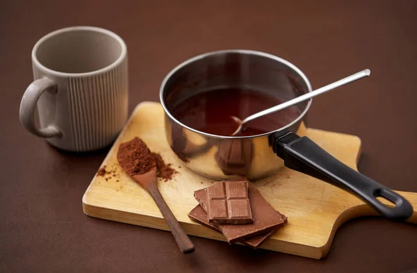 Panci dengan coklat panas, cangkir dan bubuk kakao — Stok Foto