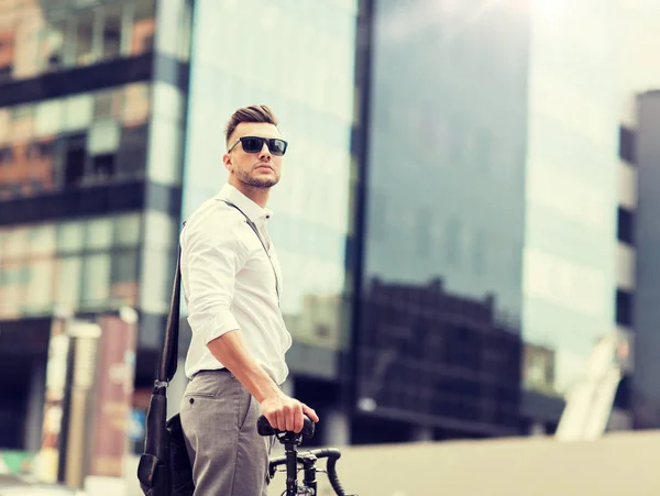 Young man with bicycle on city street — Stock Photo, Image