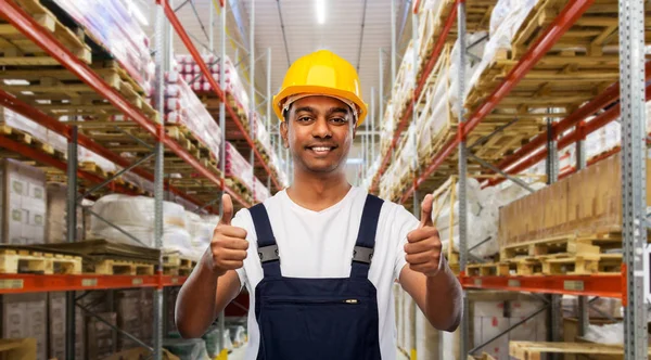 Happy indian worker showing thumbs up at warehouse — Stock Photo, Image